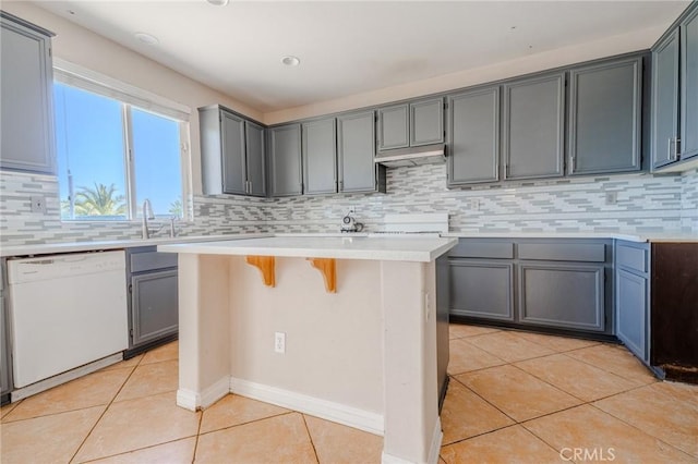 11818 Forest Park Ln, Victorville, CA 92392 - kitchen with dishwasher, light tile patterned floors, tasteful backsplash, and light countertops
