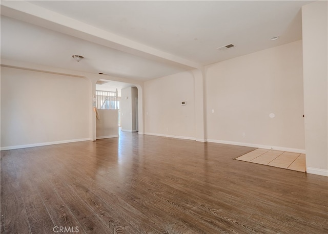 11818 Forest Park Ln, Victorville, CA 92392 - spare room with arched walkways and wood finished floors