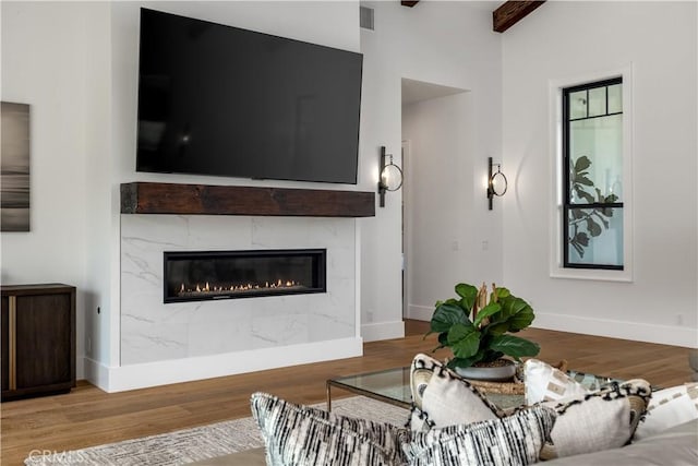 3325 Sagewood Hills Rd, Vista, CA 92084 - living area featuring wood finished floors, a premium fireplace, and beam ceiling