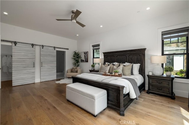 3325 Sagewood Hills Rd, Vista, CA 92084 - bedroom featuring a barn door, light wood-type flooring, recessed lighting, and a ceiling fan