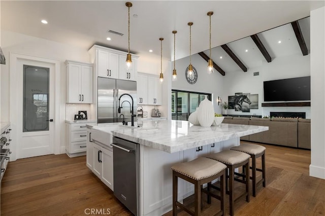 3325 Sagewood Hills Rd, Vista, CA 92084 - kitchen with stainless steel appliances, a large island with sink, white cabinets, dark wood-style floors, and recessed lighting