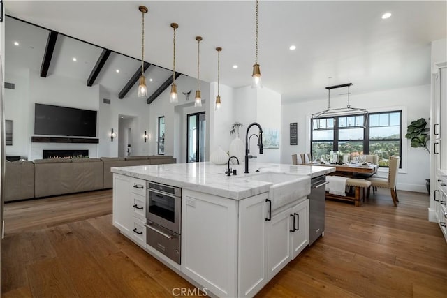 3325 Sagewood Hills Rd, Vista, CA 92084 - kitchen featuring a warming drawer, an island with sink, white cabinetry, light stone counters, and stainless steel dishwasher
