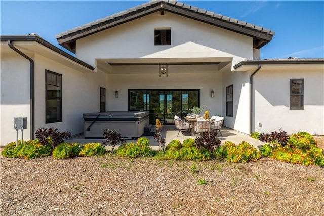 3325 Sagewood Hills Rd, Vista, CA 92084 - rear view of property featuring a hot tub, a patio, and stucco siding