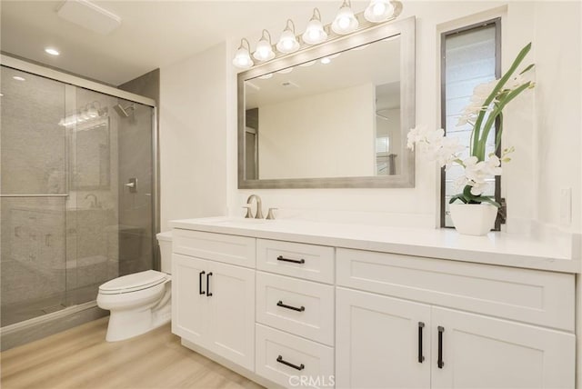 8645 Butte Cir Unit 603C, Huntington Beach, CA 92646 - bathroom featuring vanity, a shower stall, wood finished floors, and recessed lighting