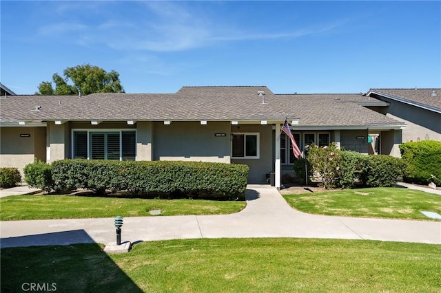 8645 Butte Cir Unit 603C, Huntington Beach, CA 92646 - ranch-style house with stucco siding, a front yard, and roof with shingles