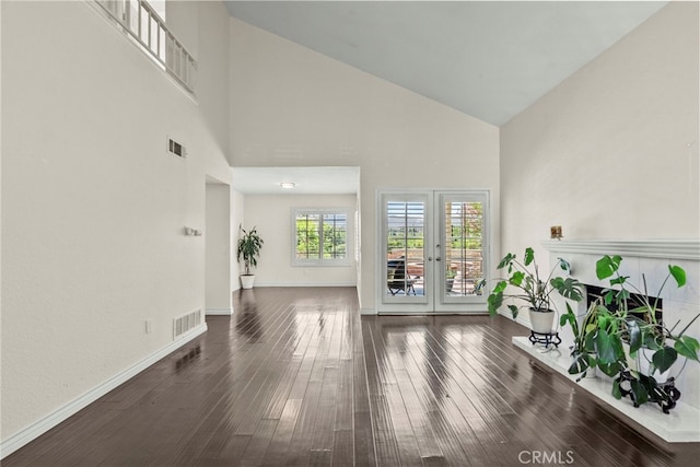 808 Links View Dr, Simi Valley, CA 93065 - living room with high vaulted ceiling, hardwood / wood-style flooring, a tile fireplace, and french doors