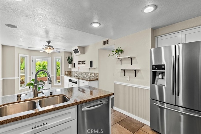 808 Links View Dr, Simi Valley, CA 93065 - kitchen with appliances with stainless steel finishes, a textured ceiling, white cabinetry, dark stone counters, and ceiling fan