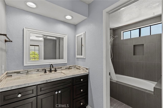 808 Links View Dr, Simi Valley, CA 93065 - bathroom with vanity, tiled shower / bath combo, a textured wall, and a ceiling fan