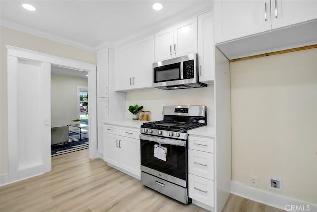 293 E Congress St, Colton, CA 92324 - kitchen featuring stainless steel appliances, light wood-style flooring, white cabinetry, light countertops, and recessed lighting