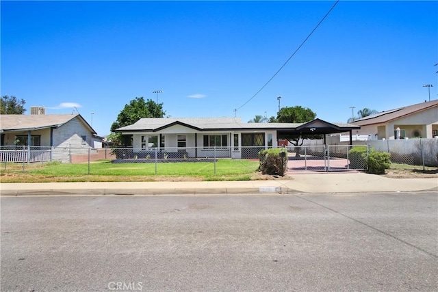 293 E Congress St, Colton, CA 92324 - view of front facade featuring driveway, a fenced front yard, a carport, and a gate
