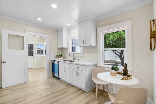 293 E Congress St, Colton, CA 92324 - kitchen featuring dishwasher, ornamental molding, light countertops, white cabinetry, and light wood-style flooring
