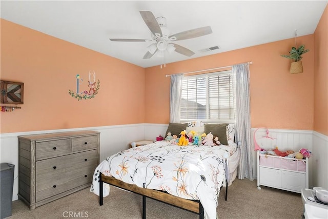 1101 Admiral Ln, Chico, CA 95973 - carpeted bedroom featuring a wainscoted wall and ceiling fan