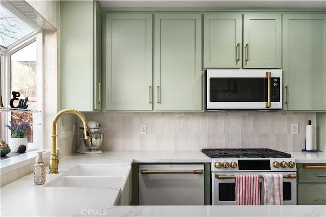 1101 Admiral Ln, Chico, CA 95973 - kitchen with green cabinetry, white microwave, stainless steel gas stove, and dishwasher