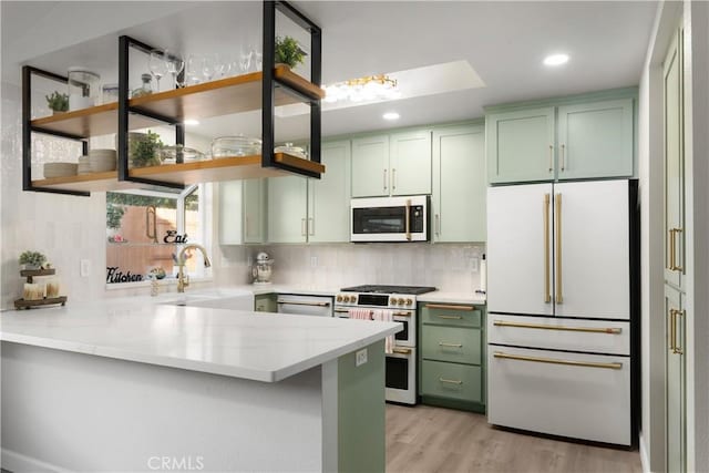1101 Admiral Ln, Chico, CA 95973 - kitchen with high end appliances, green cabinetry, open shelves, a peninsula, and backsplash