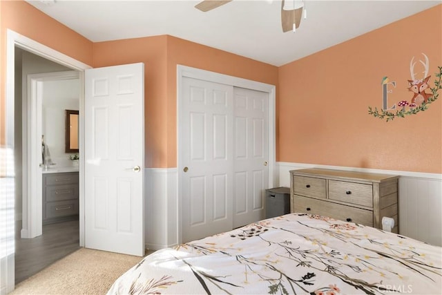 1101 Admiral Ln, Chico, CA 95973 - bedroom featuring a closet, wainscoting, light colored carpet, and a ceiling fan