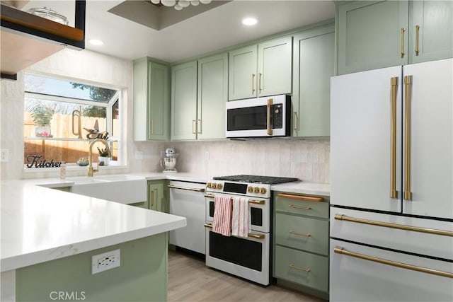 1101 Admiral Ln, Chico, CA 95973 - kitchen with white appliances, green cabinets, light countertops, tasteful backsplash, and recessed lighting
