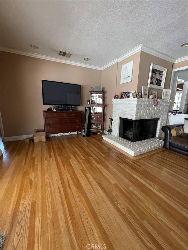 7957 Sausalito Ave, West Hills, CA 91304 - living area with a brick fireplace, light wood-style flooring, ornamental molding, and a textured ceiling