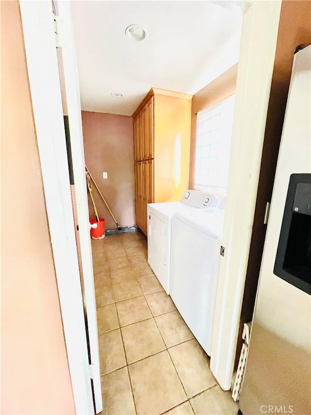 7957 Sausalito Ave, West Hills, CA 91304 - washroom with washer and dryer, light tile patterned floors, and cabinet space