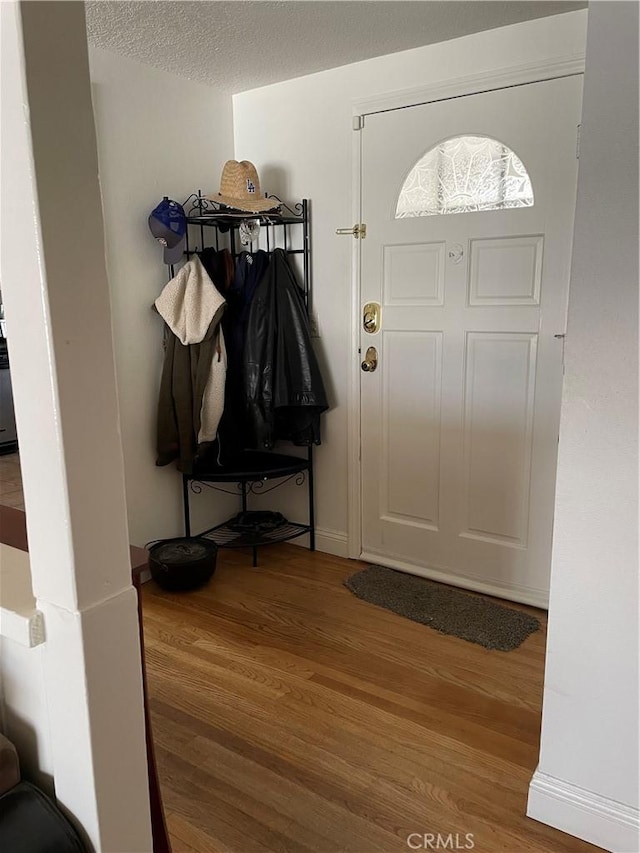 7957 Sausalito Ave, West Hills, CA 91304 - entryway with wood finished floors and a textured ceiling