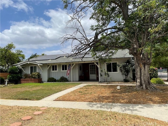7957 Sausalito Ave, West Hills, CA 91304 - ranch-style home with a front yard, roof mounted solar panels, a shingled roof, and board and batten siding