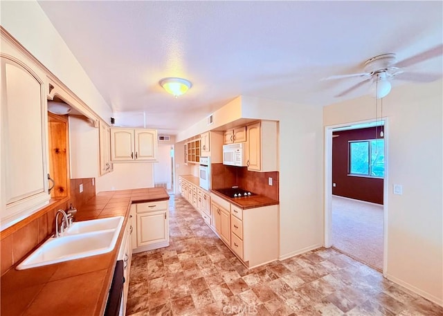 27294 Pinehurst Rd, Menifee, CA 92586 - kitchen with white appliances, a ceiling fan, cream cabinetry, tasteful backsplash, and tile countertops