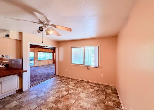 27294 Pinehurst Rd, Menifee, CA 92586 - unfurnished room featuring a ceiling fan and stone finish flooring