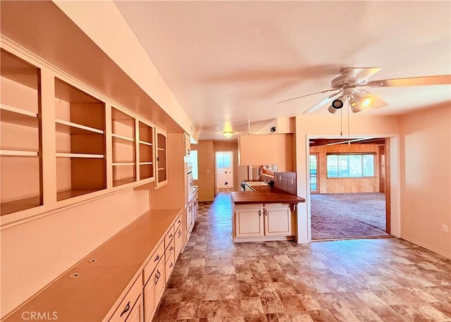 27294 Pinehurst Rd, Menifee, CA 92586 - kitchen featuring a ceiling fan, stone finish flooring, carpet flooring, and butcher block countertops