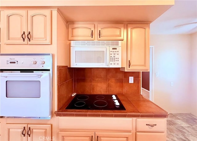 27294 Pinehurst Rd, Menifee, CA 92586 - kitchen featuring white appliances, tile countertops, cream cabinets, and tasteful backsplash