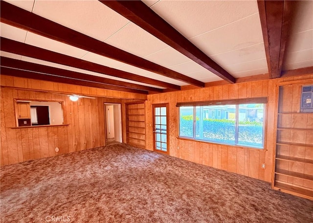 27294 Pinehurst Rd, Menifee, CA 92586 - carpeted empty room with wood walls and beam ceiling