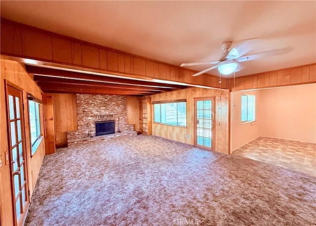 27294 Pinehurst Rd, Menifee, CA 92586 - unfurnished living room with wooden walls, healthy amount of natural light, a fireplace, carpet flooring, and a ceiling fan