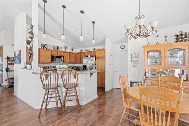 1269 Country Hill Rd, Santa Maria, CA 93455 - kitchen featuring stainless steel appliances, lofted ceiling, a peninsula, dark wood-type flooring, and decorative light fixtures