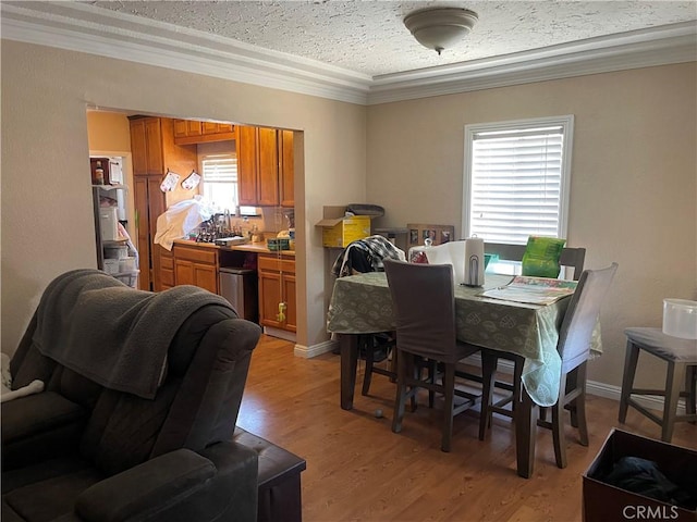 13213 Leffingwell Rd, Whittier, CA 90605 - dining area with crown molding, light wood-style floors, and a textured ceiling