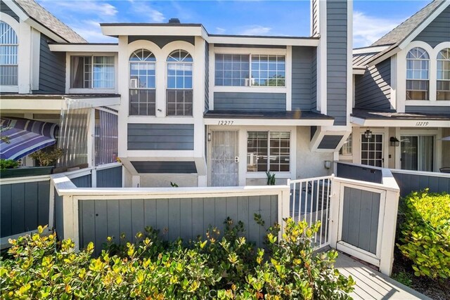 12277 Foster Rd, Norwalk, CA 90650 - view of front of house with stucco siding and a chimney