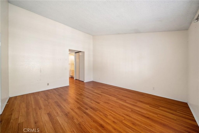 12277 Foster Rd, Norwalk, CA 90650 - unfurnished room with wood finished floors and a textured ceiling