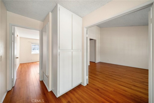 12277 Foster Rd, Norwalk, CA 90650 - hall featuring wood finished floors and a textured ceiling