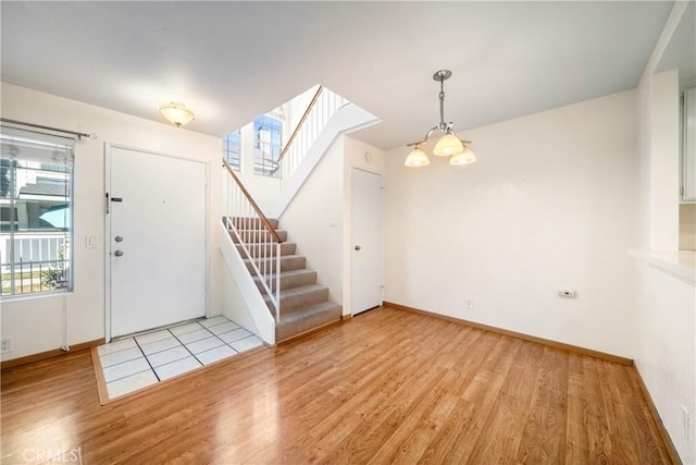 12277 Foster Rd, Norwalk, CA 90650 - entrance foyer featuring light wood finished floors, healthy amount of natural light, and stairway