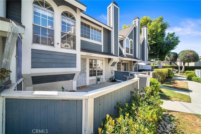 12277 Foster Rd, Norwalk, CA 90650 - rear view of house featuring a chimney