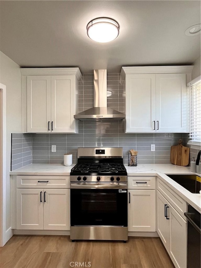 1610 266th St, Harbor City, CA 90710 - kitchen with wall chimney range hood, stainless steel gas range, light wood-type flooring, and dishwashing machine