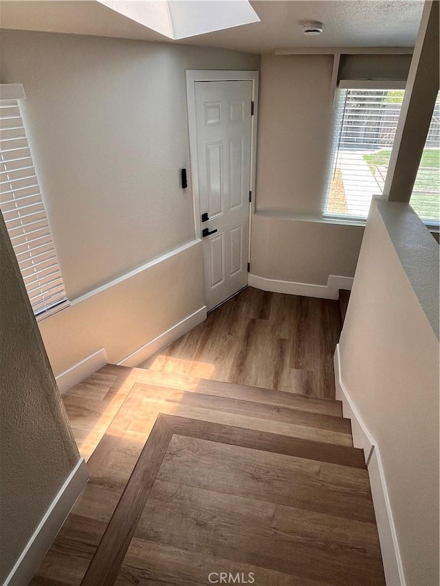 1610 266th St, Harbor City, CA 90710 - staircase featuring wood finished floors and a skylight