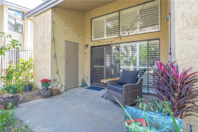 4900 E Chapman Ave Unit 24, Orange, CA 92869 - doorway to property featuring stucco siding and a patio area