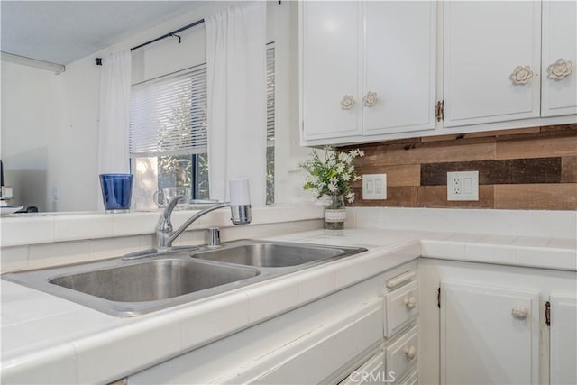 4900 E Chapman Ave Unit 24, Orange, CA 92869 - kitchen featuring white cabinets, backsplash, and tile counters