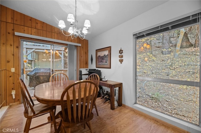 103 Rockledge Ln, Lake Arrowhead, CA 92352 - dining space with a chandelier, light wood-type flooring, healthy amount of natural light, and wooden walls