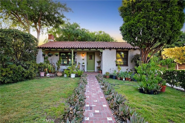 404 N Vinedo Ave, Pasadena, CA 91107 - mediterranean / spanish home featuring stucco siding, a lawn, covered porch, and a chimney