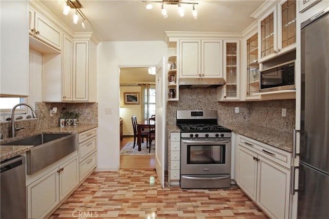 404 N Vinedo Ave, Pasadena, CA 91107 - kitchen featuring stainless steel appliances, tasteful backsplash, under cabinet range hood, light stone countertops, and glass insert cabinets