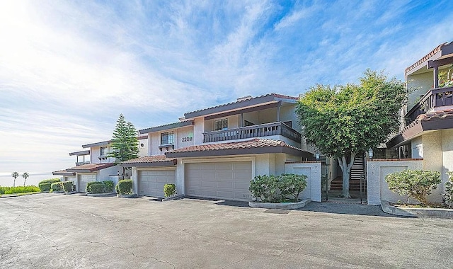 2209 W 25th St Unit 7, San Pedro, CA 90732 - mediterranean / spanish-style home with stucco siding, a tiled roof, a garage, and a balcony