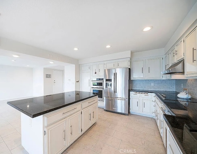2209 W 25th St Unit 7, San Pedro, CA 90732 - kitchen featuring appliances with stainless steel finishes, under cabinet range hood, tasteful backsplash, a center island, and recessed lighting