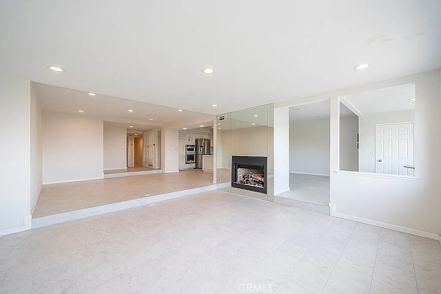 2209 W 25th St Unit 7, San Pedro, CA 90732 - unfurnished living room featuring recessed lighting and a multi sided fireplace