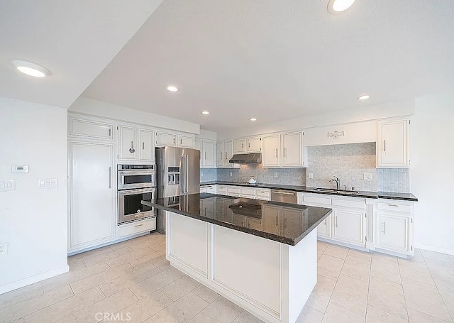 2209 W 25th St Unit 7, San Pedro, CA 90732 - kitchen with appliances with stainless steel finishes, under cabinet range hood, backsplash, white cabinets, and recessed lighting