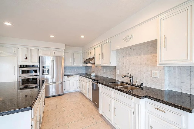 2209 W 25th St Unit 7, San Pedro, CA 90732 - kitchen with stainless steel appliances, under cabinet range hood, tasteful backsplash, white cabinets, and light tile patterned flooring