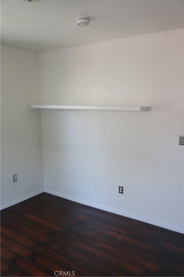15154 Oliva Ave, Paramount, CA 90723 - spare room featuring dark wood-style floors and a smoke detector